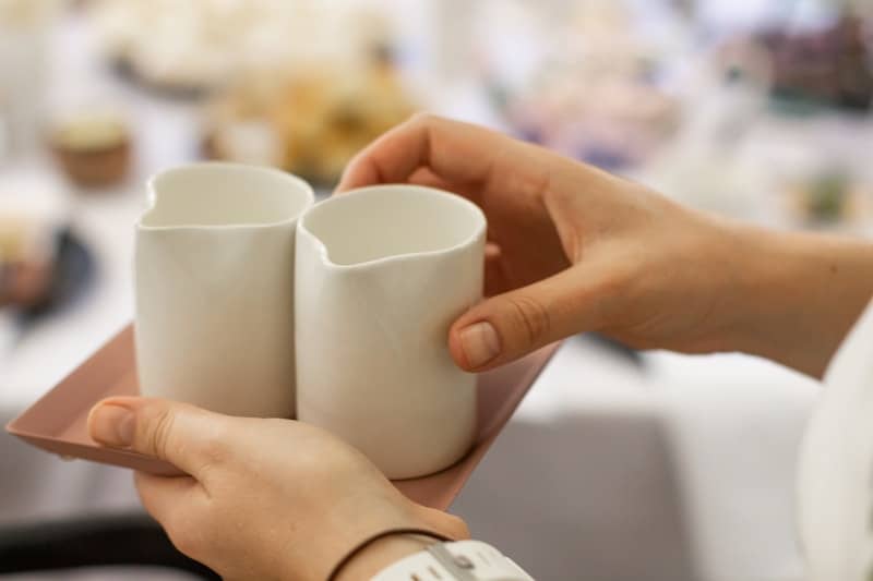 person holding white ceramic mug