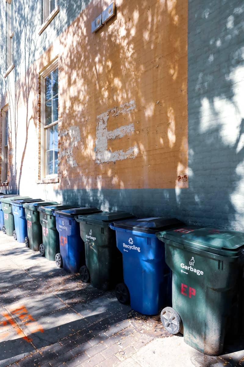 A row of trash cans sitting next to a building