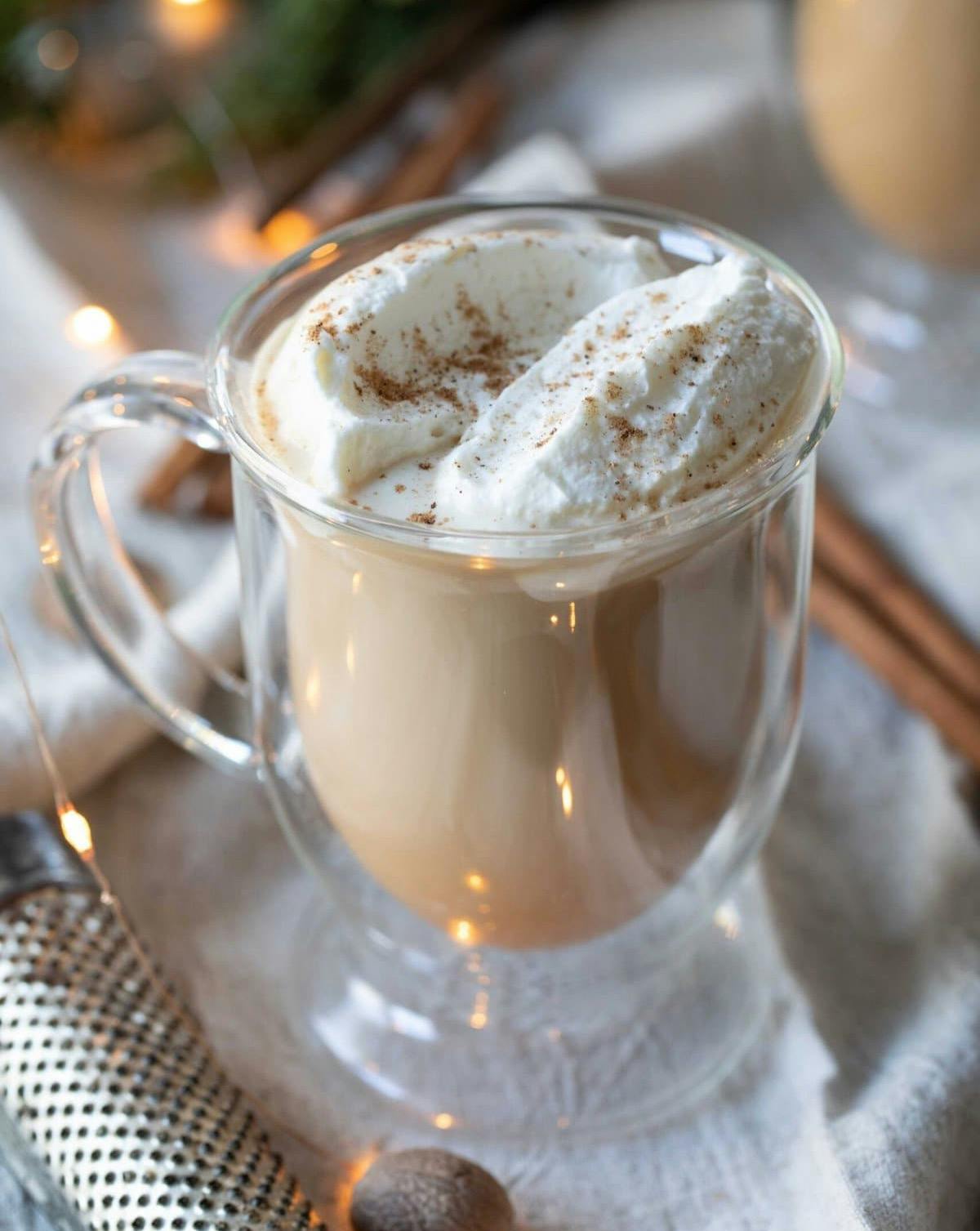 nutty Irish coffee in a clear glass mug.