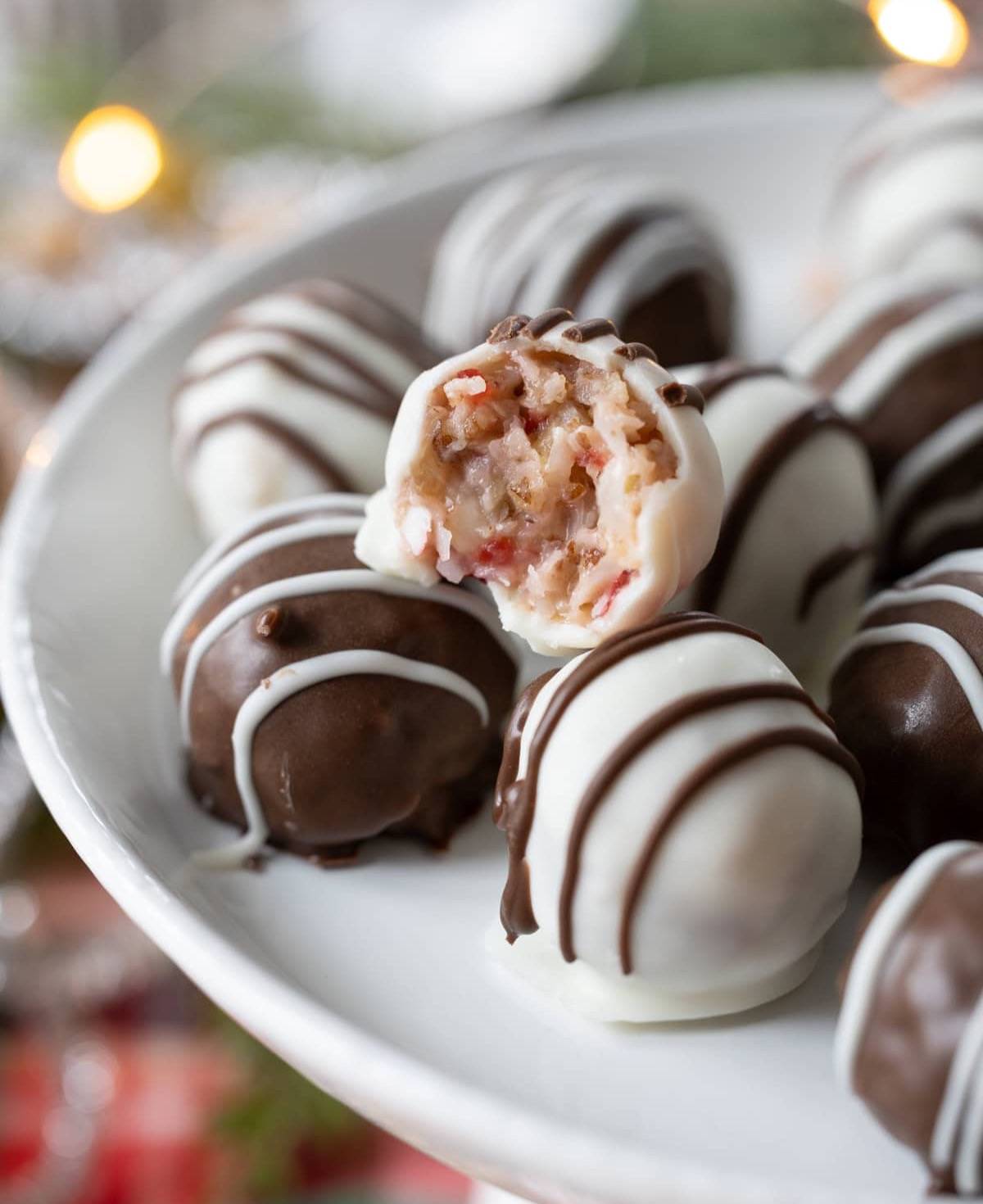 Cherry Coconut Pecan Candies in white and milk chocolate on a small cake stand. 