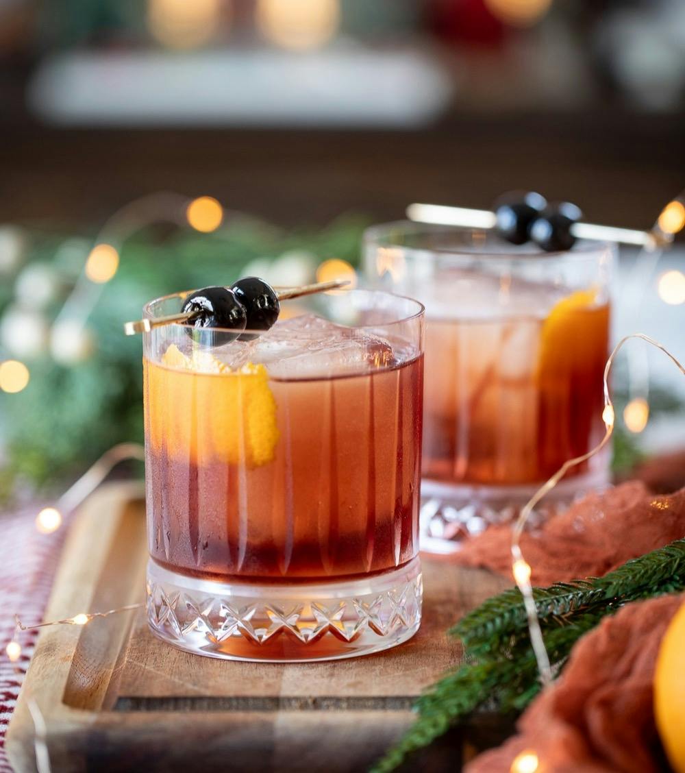 dolomite old fashioned cocktails served in glasses with festive decor.