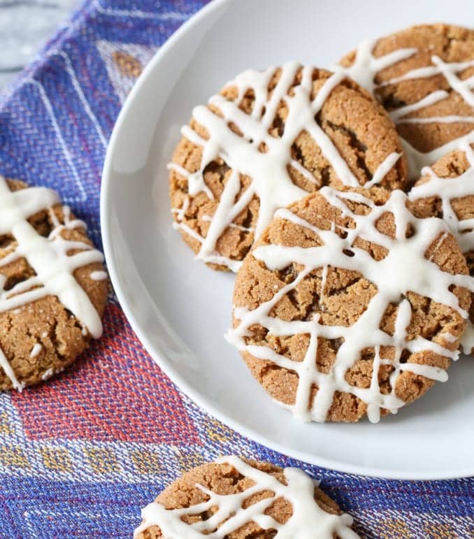 Gingersnaps with Apple Cider Glaze on a plate on a colorful napkin.