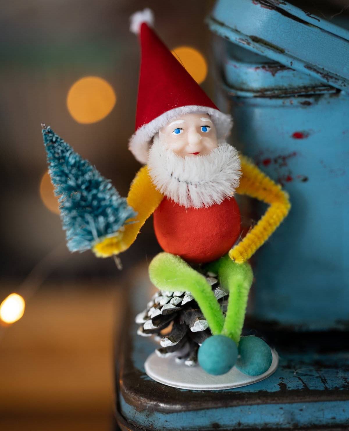 Christmas Pinecone Elf holding a tree.