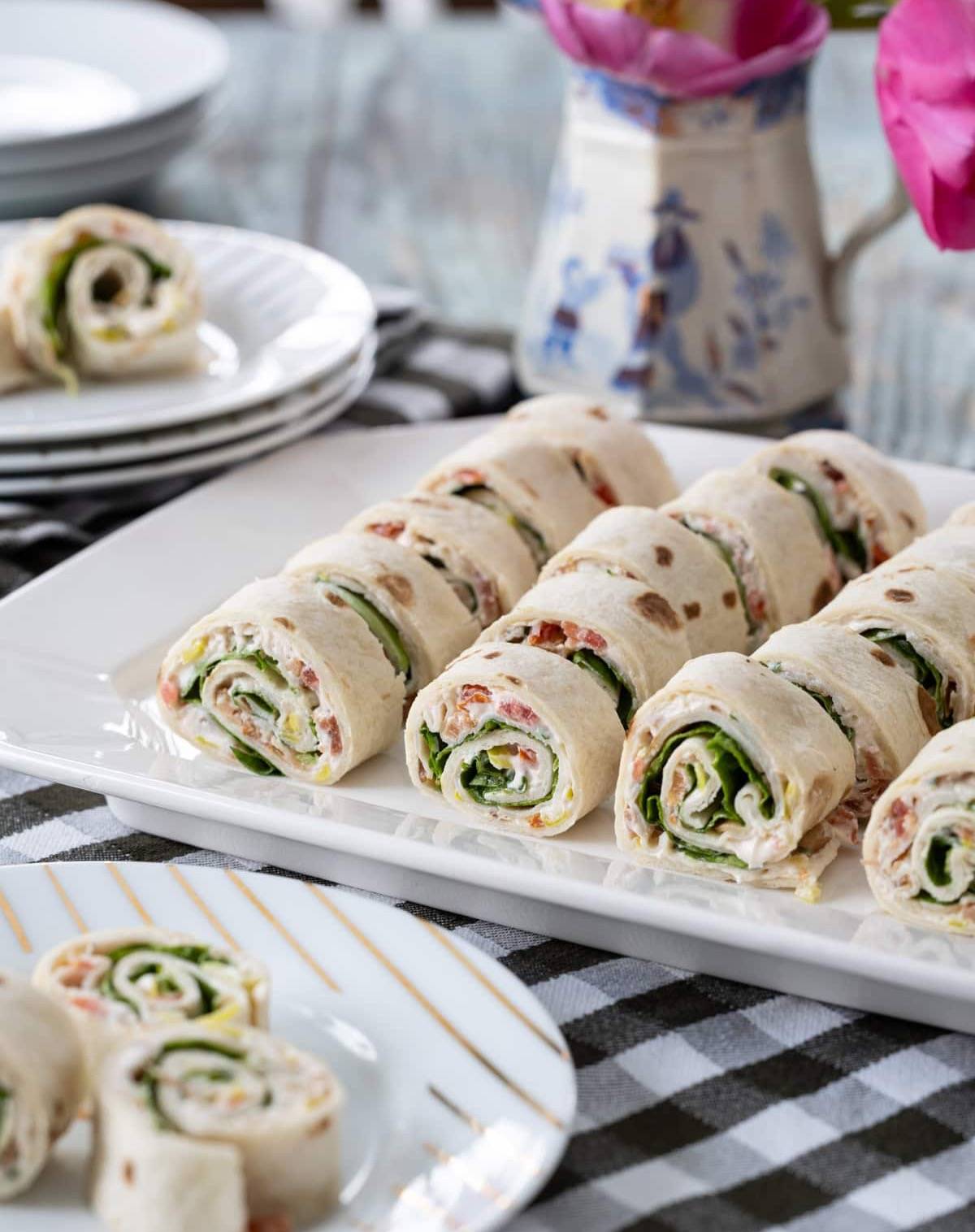 Turkey Club Sandwich Roll-Ups on a platter and a plate.