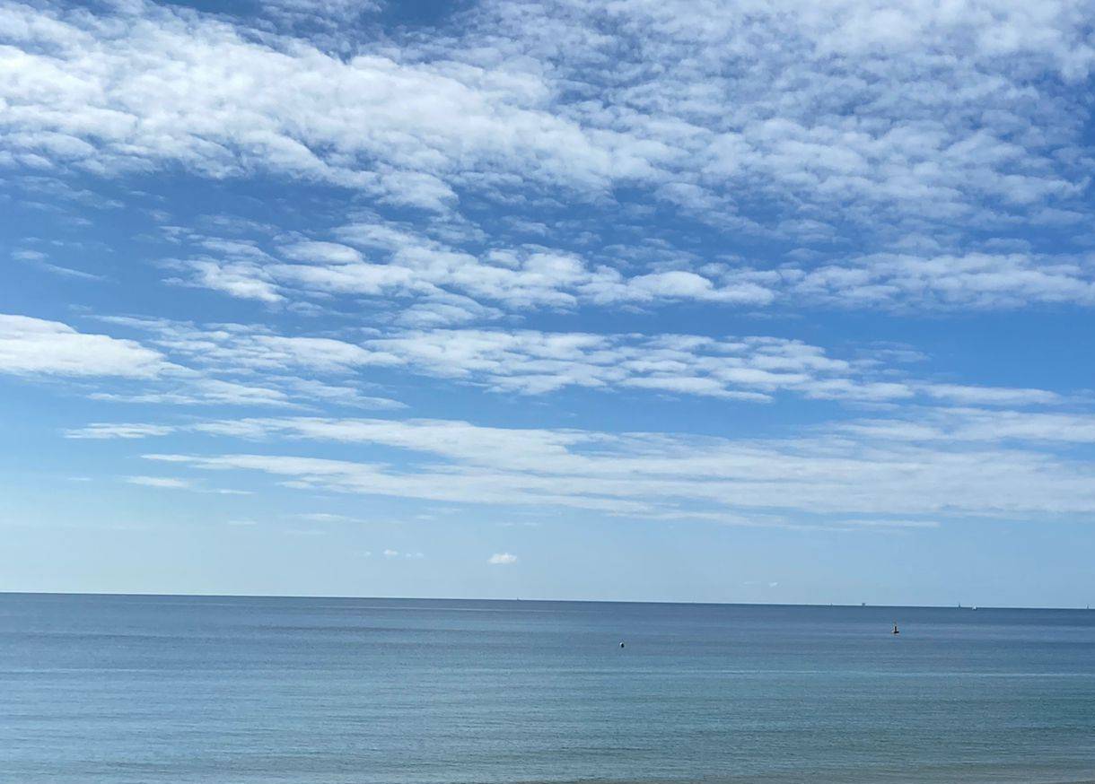 Image of beach, clear blue sky with cloud fluff, calm sea.  Two Weekends.  Image by Sheela Hobden at www.bluegreencoaching.com