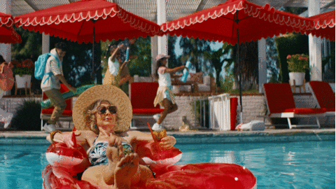 giphy of woman floating and relaxing in the pool