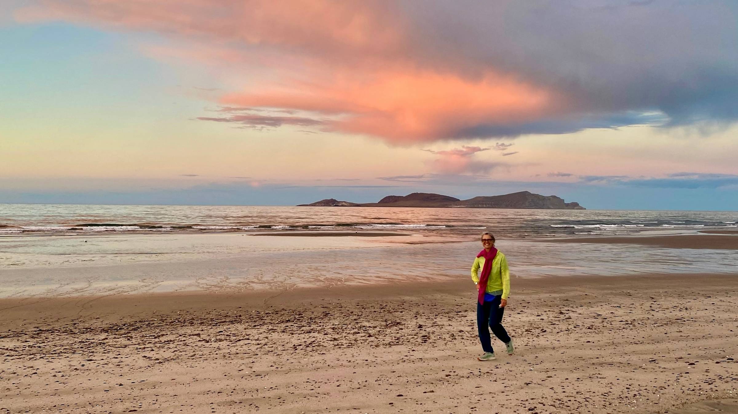 Sylke walking on a beach at sunset