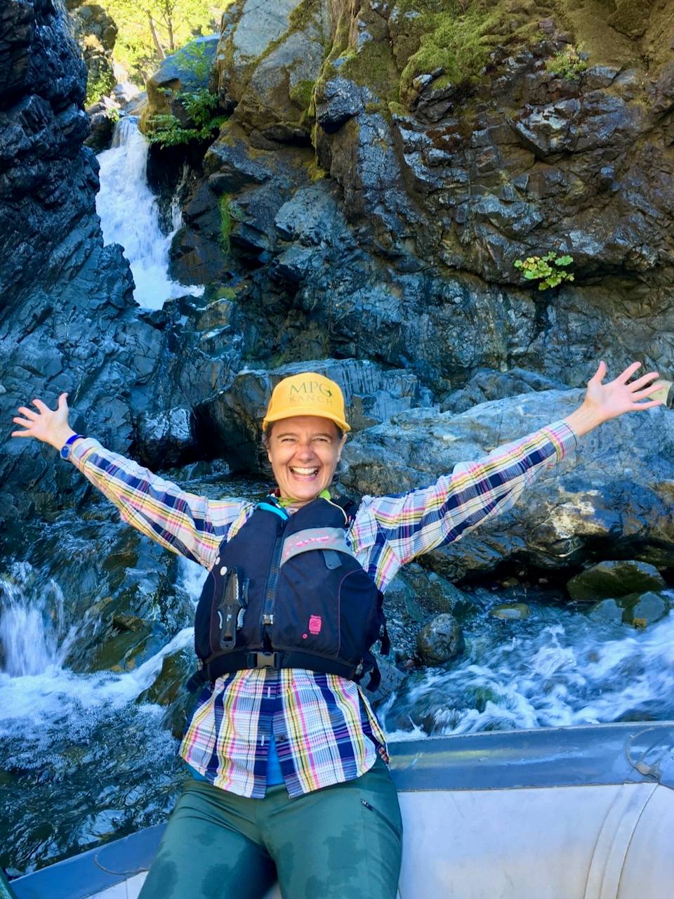 sylke cheering in front of a waterfall