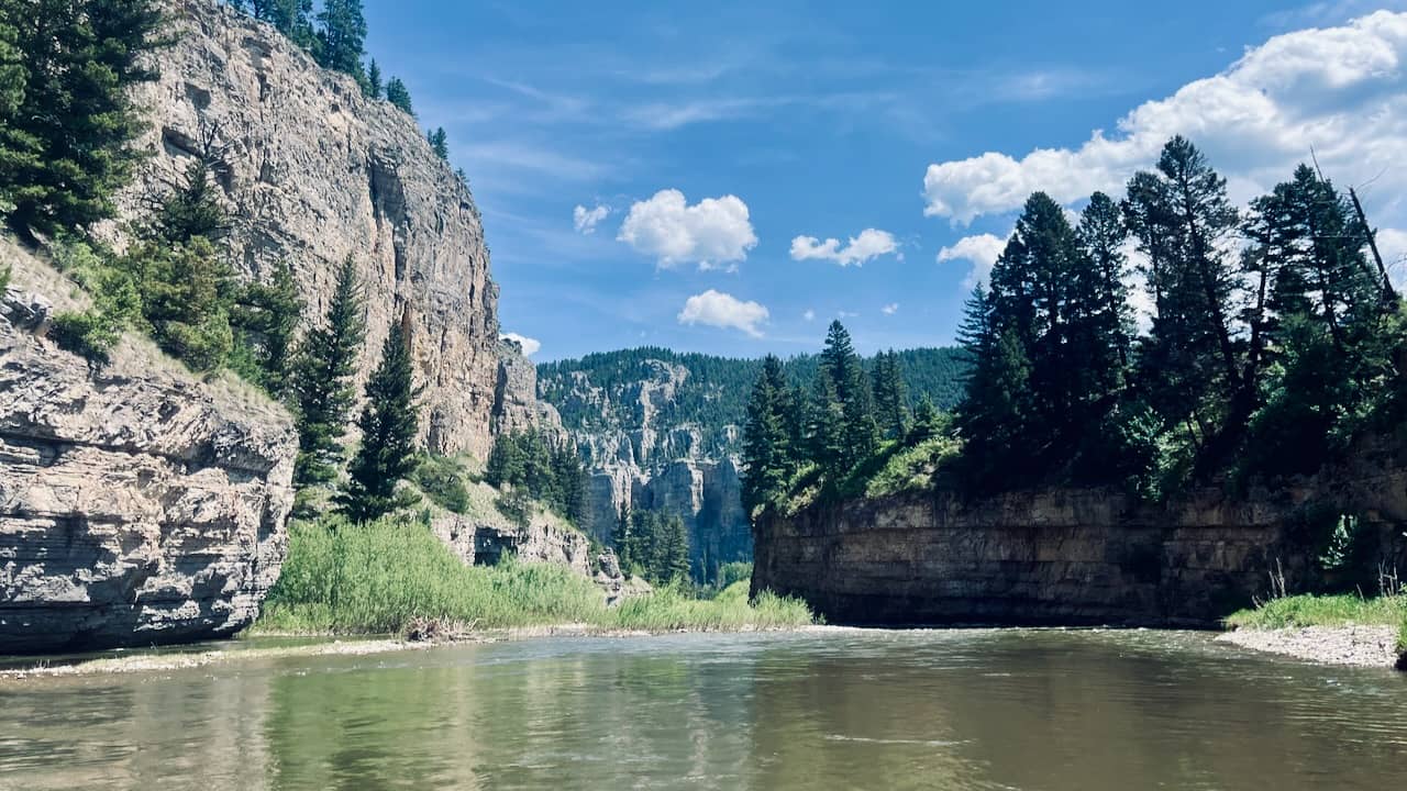 layers of cliffs and trees seen from the Smith River in Montana