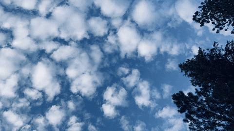 clouds moving across a blue sky