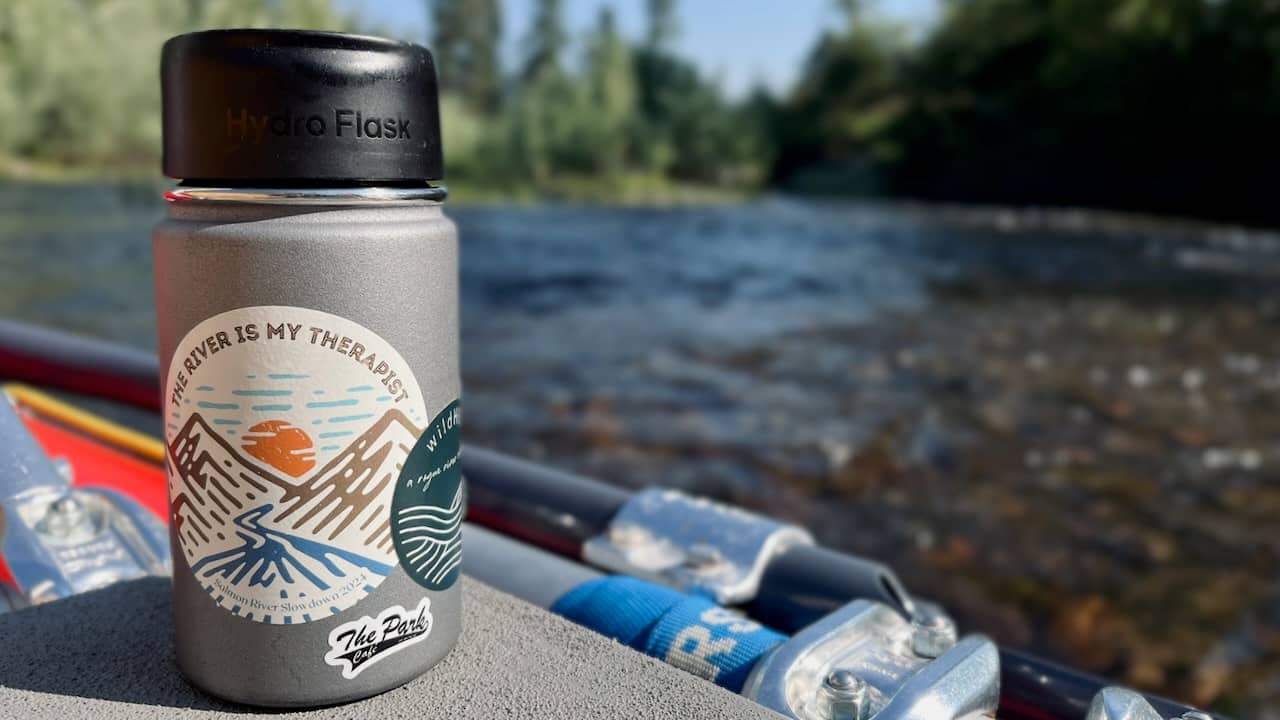 photo of a coffee mug on a raft in the middle of a river