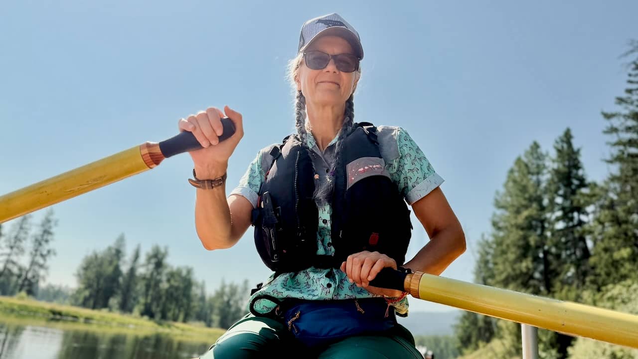 photo of the author rowing her boat down the river