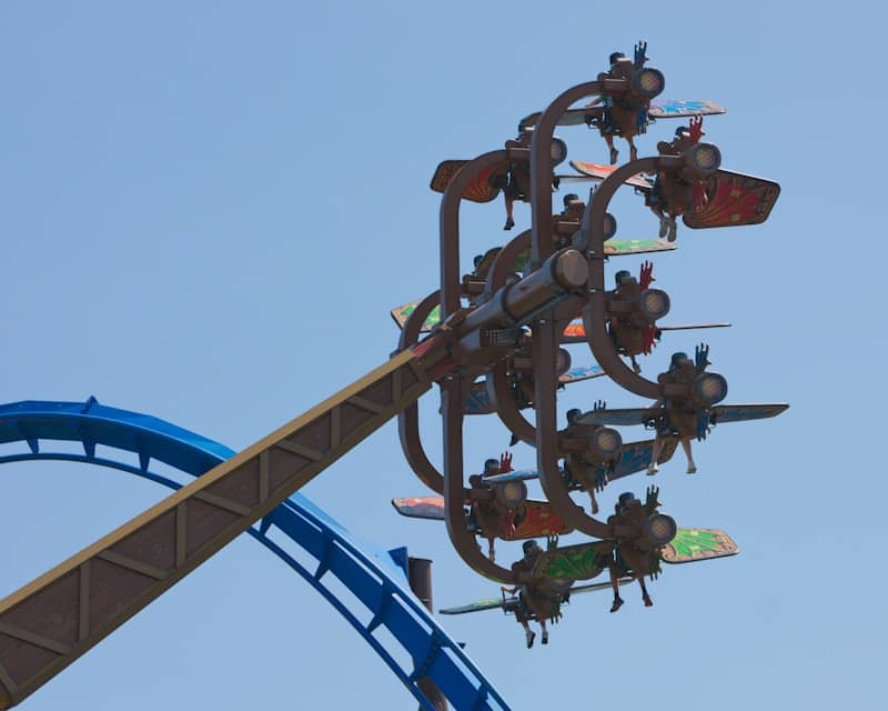 Amusement park ride with people flying around.