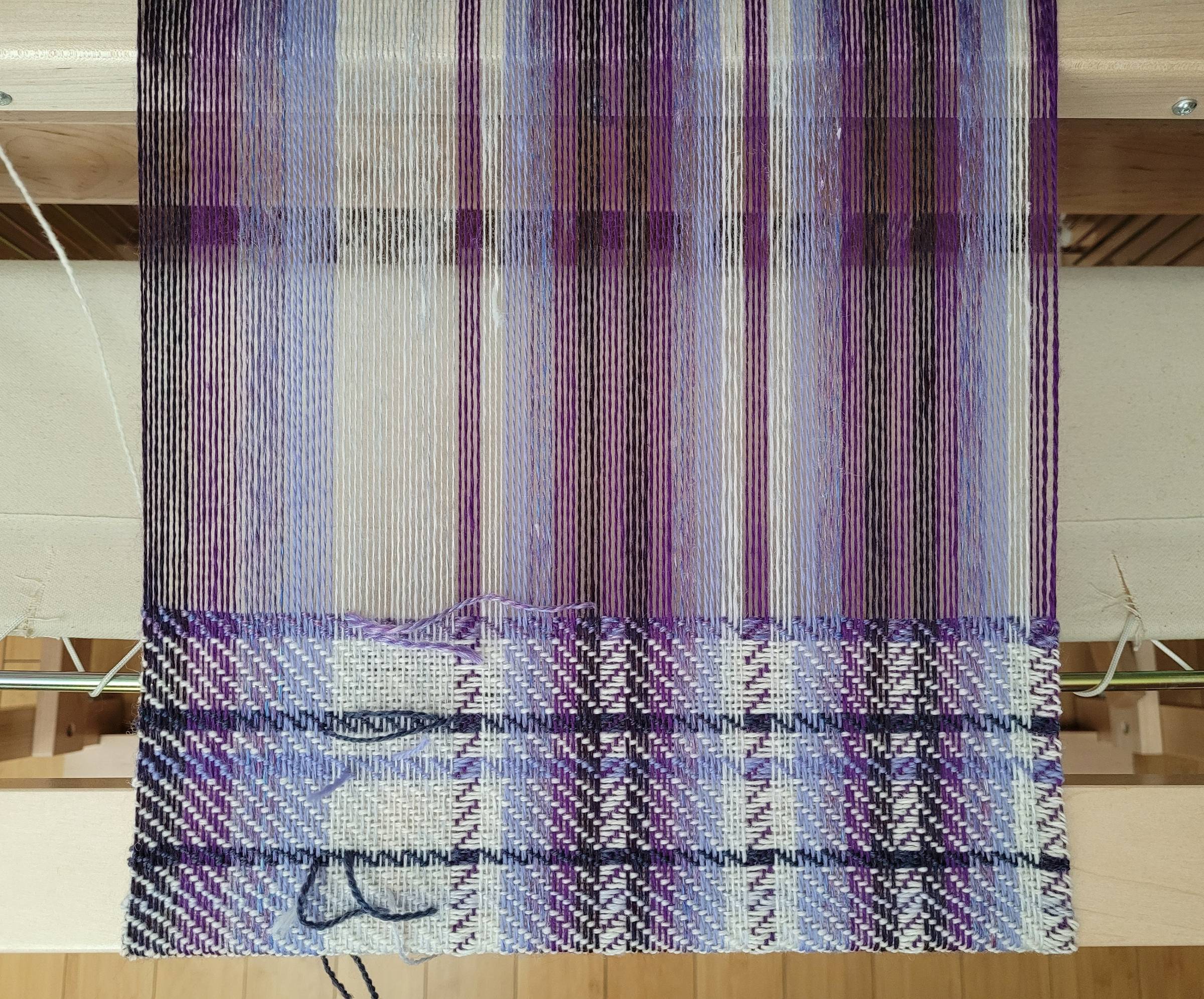 Striped twill weaving project using various shades of purple contrasted with white.