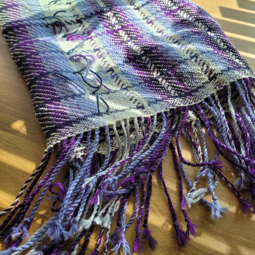 View of a handwoven twill scarf from the bottom fringe.