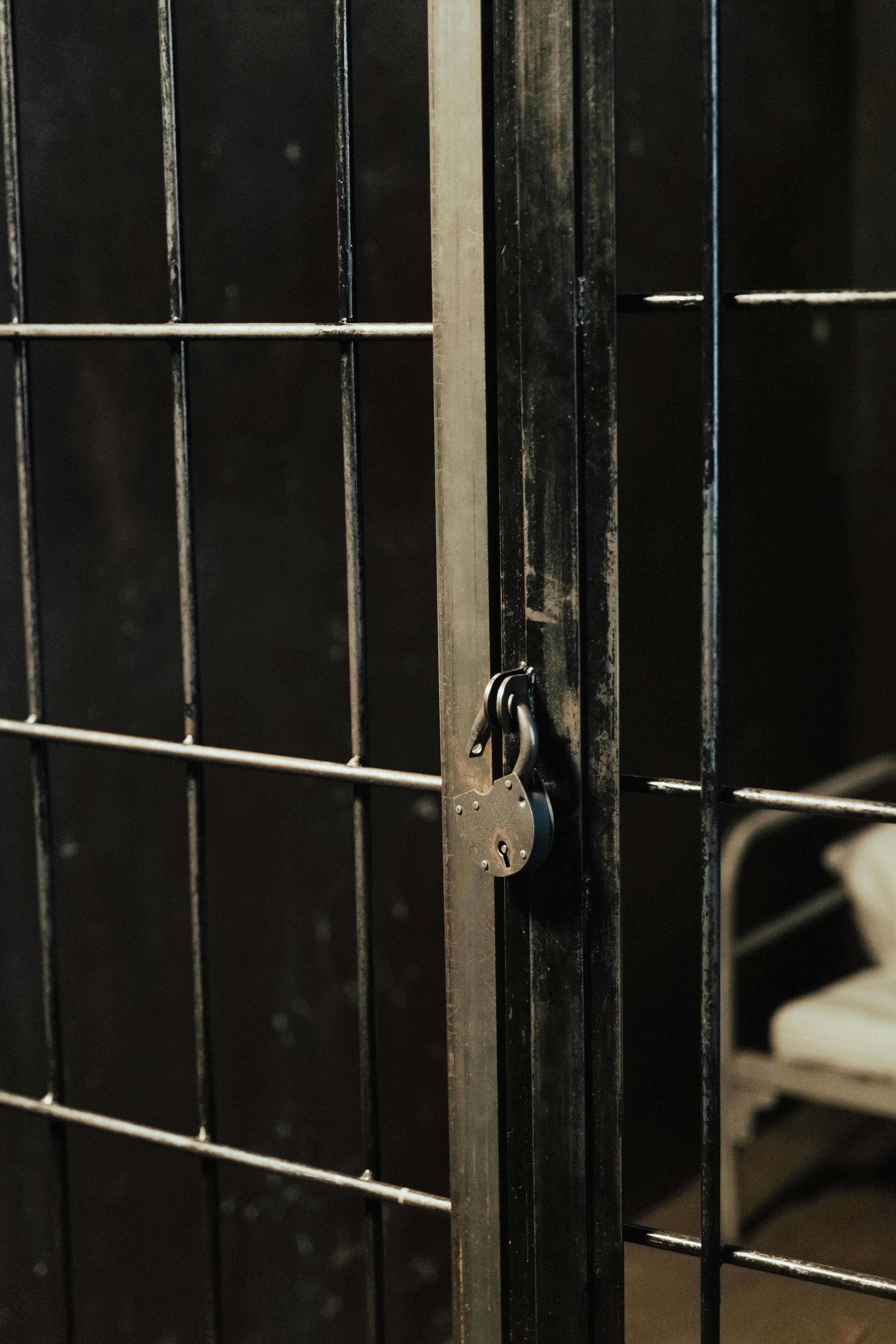 prison bars and dark background with large lock