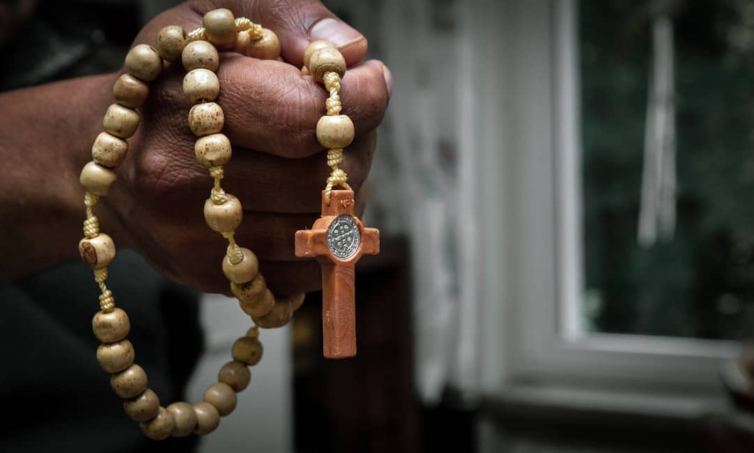 a hand with a rosary in it