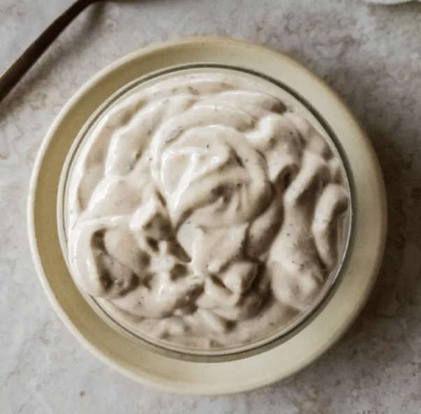 A bowl of creamy, textured sauce.