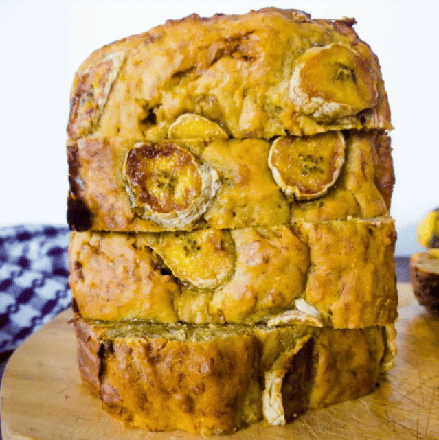 A stack of moist banana bread slices with visible chunks of banana