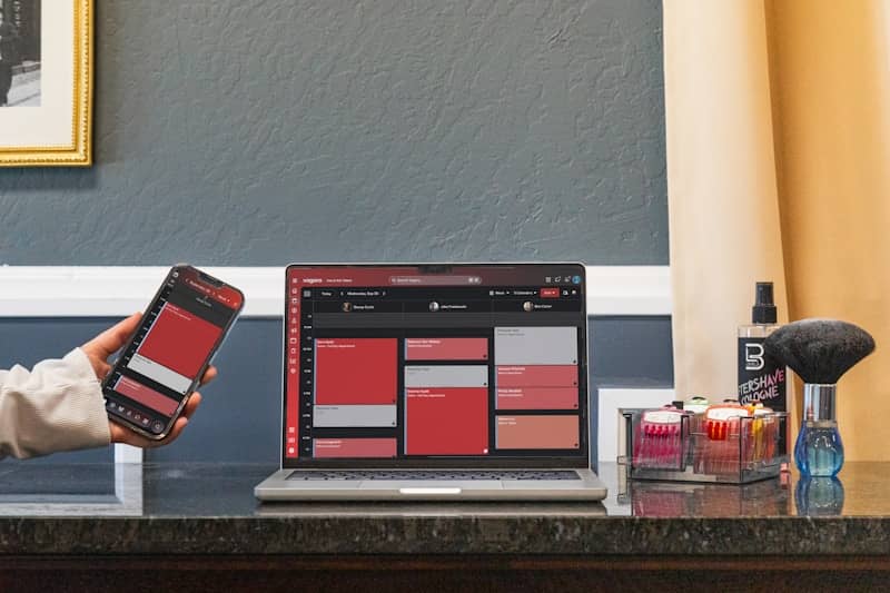 Red digital interface on smartphone and laptop with beauty products.