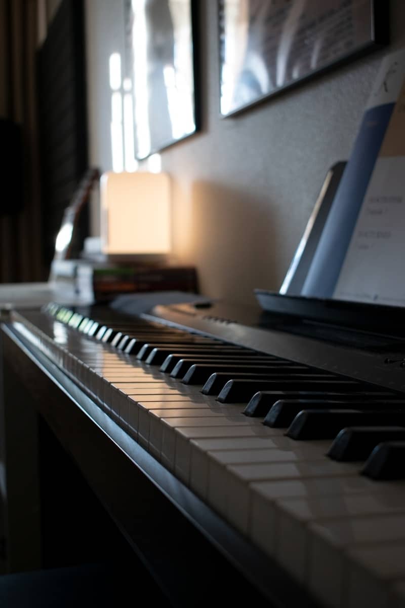 Close-up of a piano keyboard with sheet music