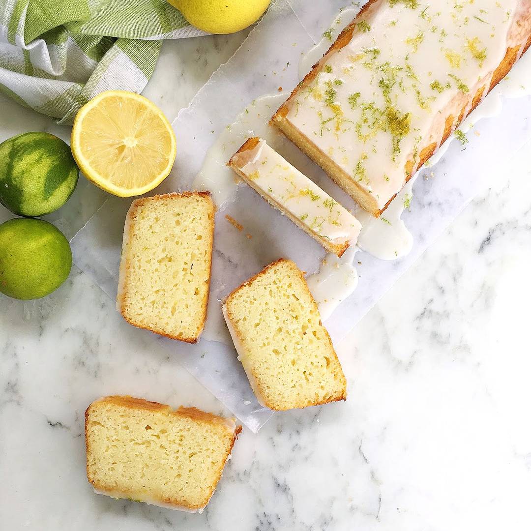 Glazed lemon lime loaf on white marble.
