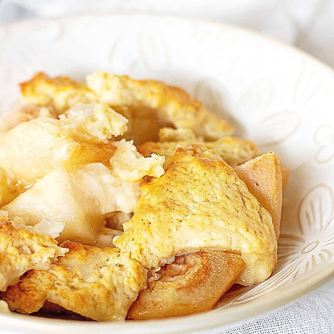 White bowl of pear cobbler serving. 