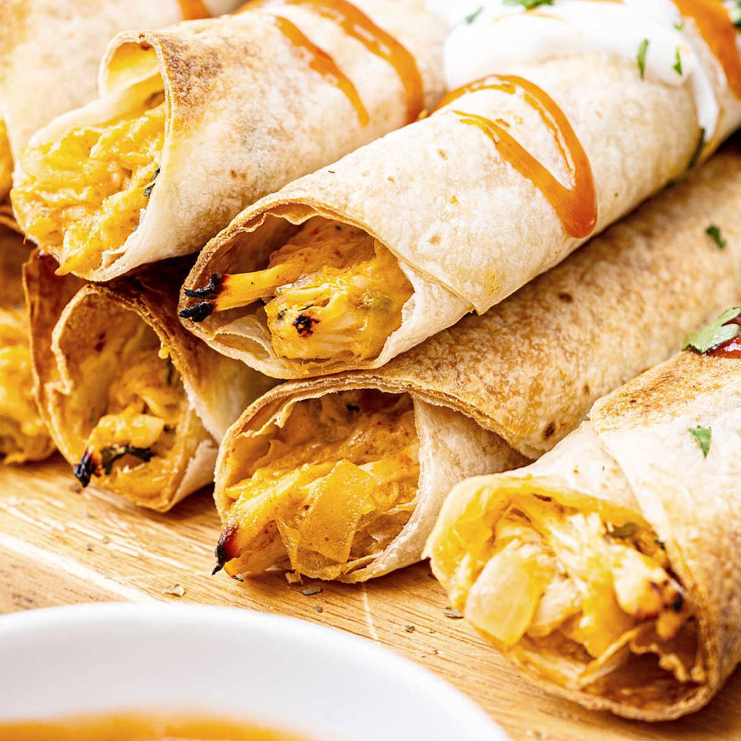 Piled chicken taquitos.