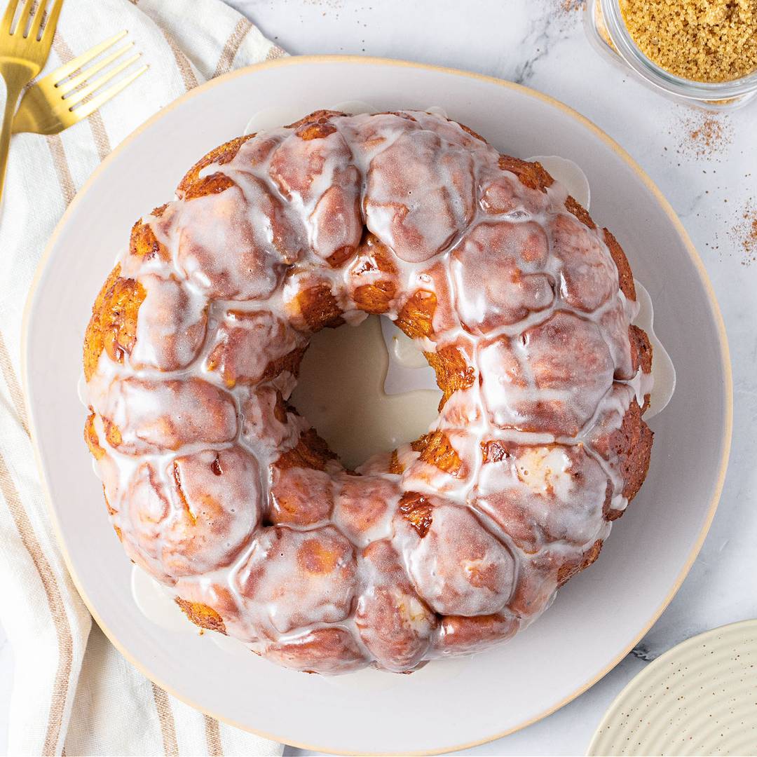 Glazed monkey bread on a white plate.