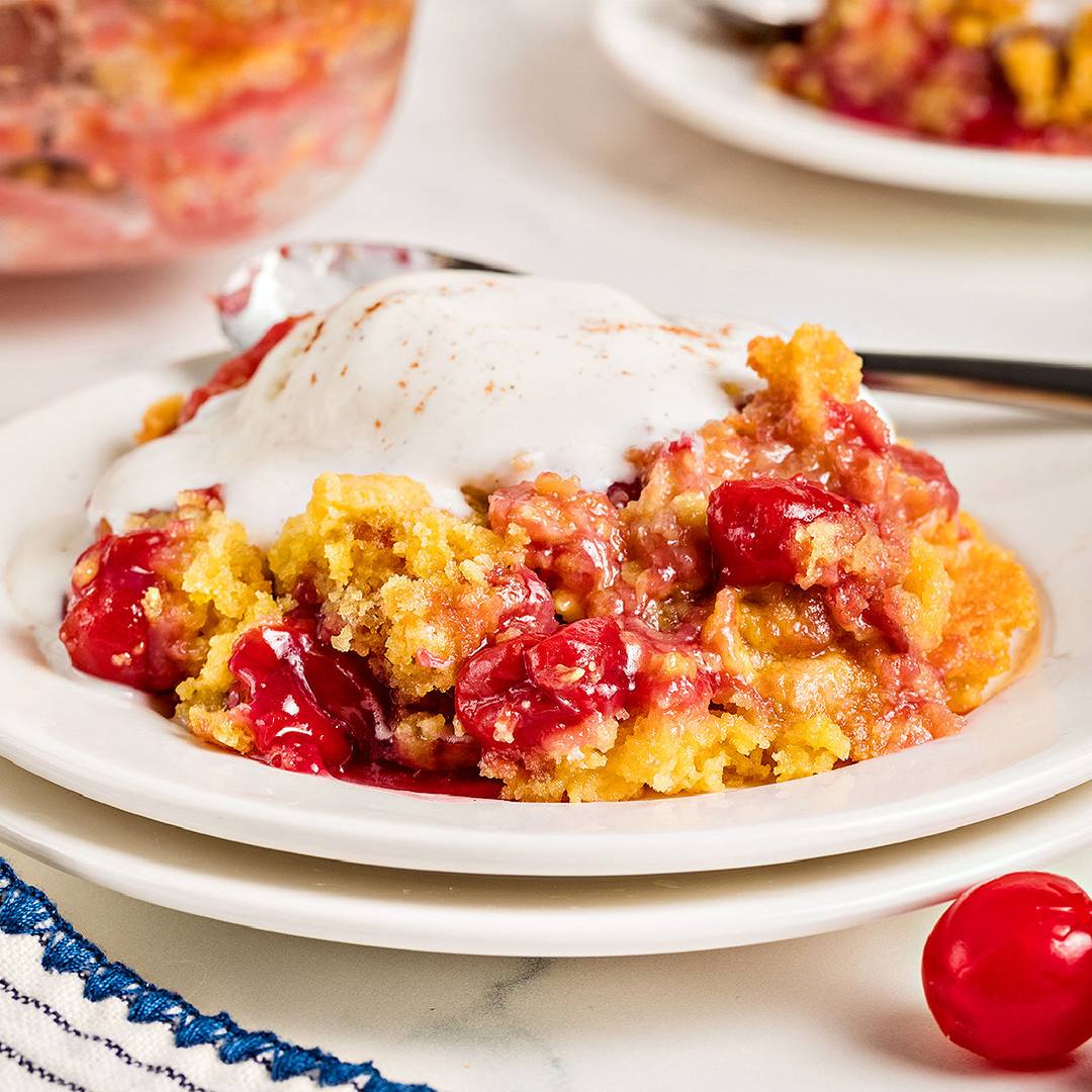 White plate of cherry dump cake.