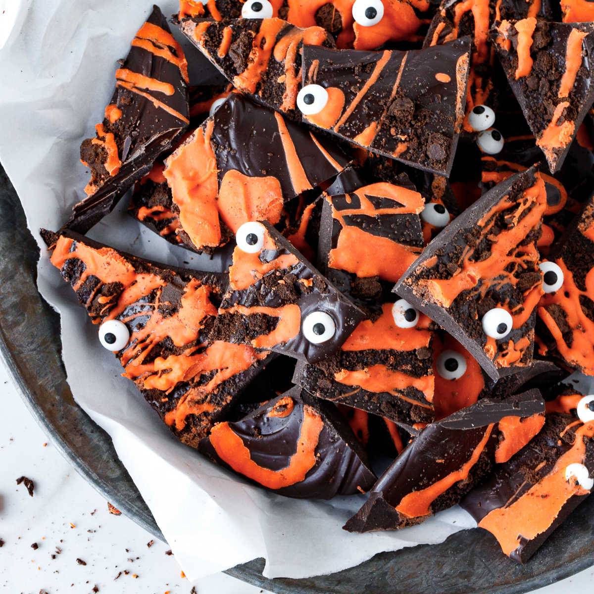 Pieces of orange and chocolate bark with candy eyes.