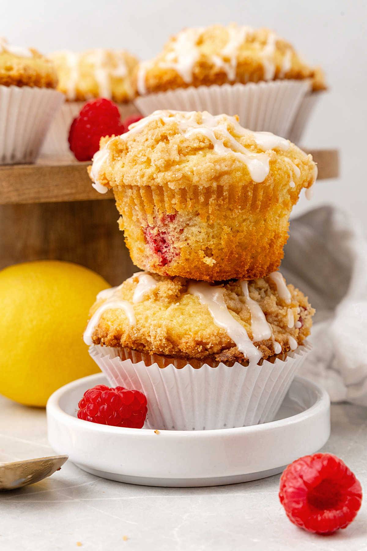 Stack of two glazed raspberry crumb muffins. 