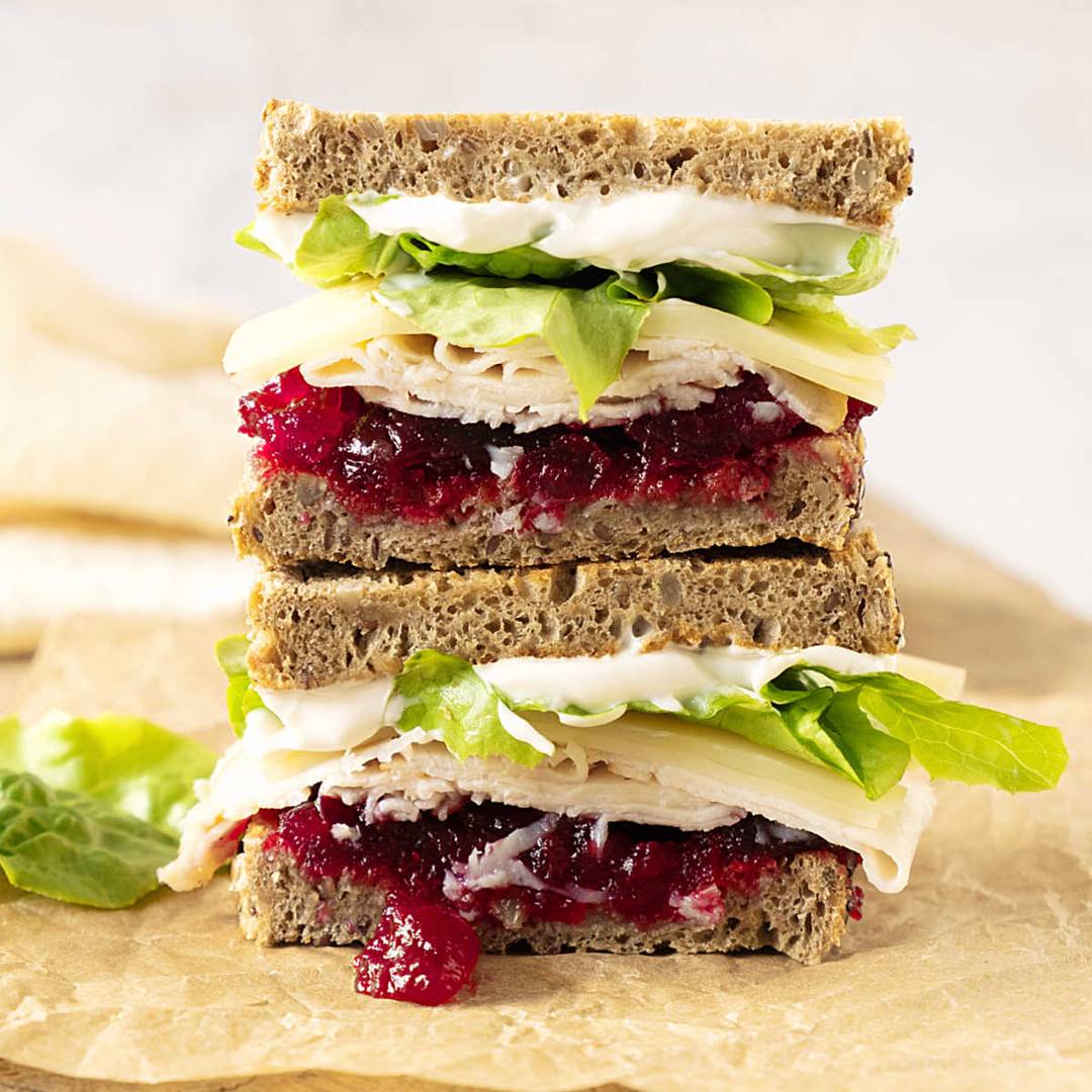 Stack of two cran turkey lettuce sandwiches.
