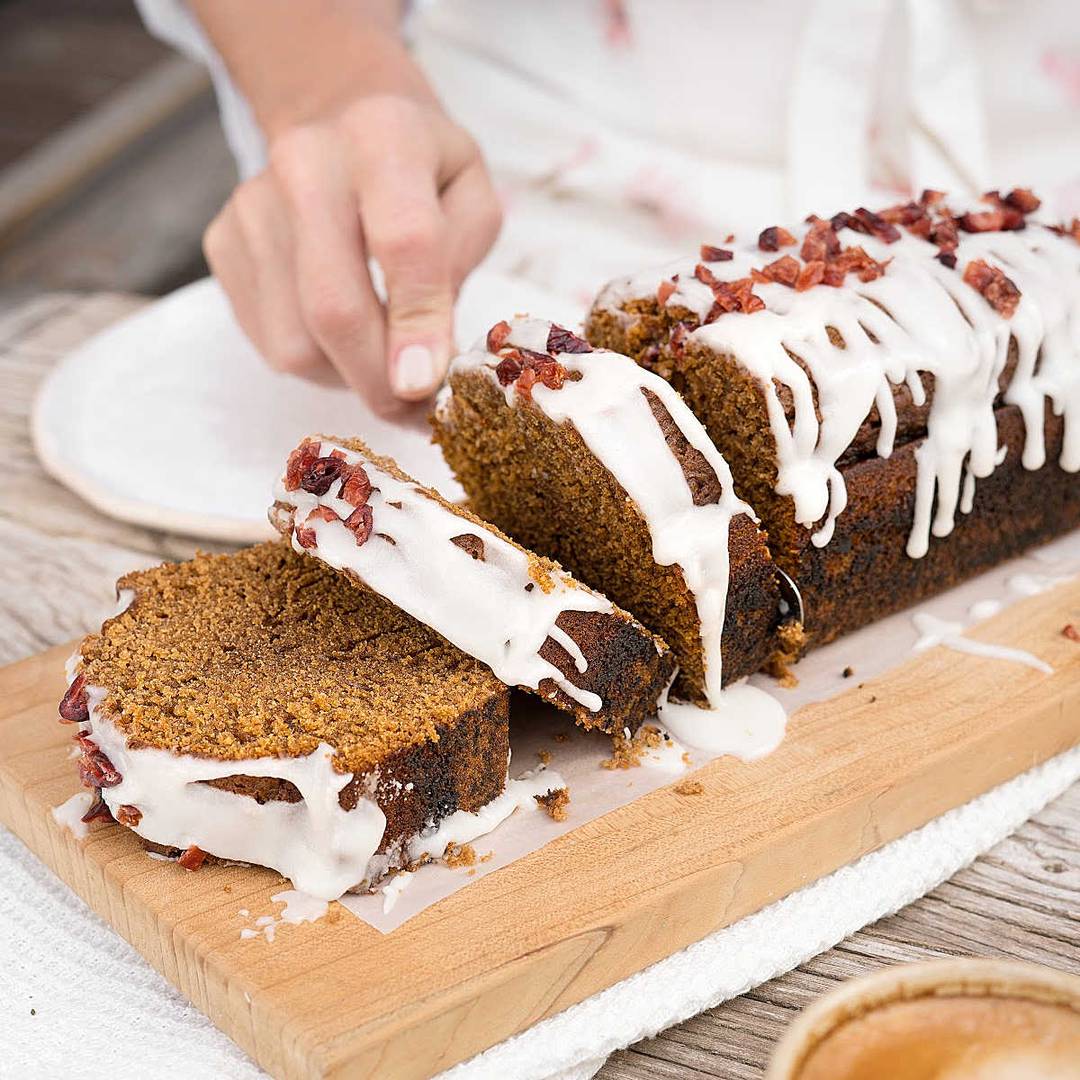 Glazed gingerbread loaf on a wooden board. 