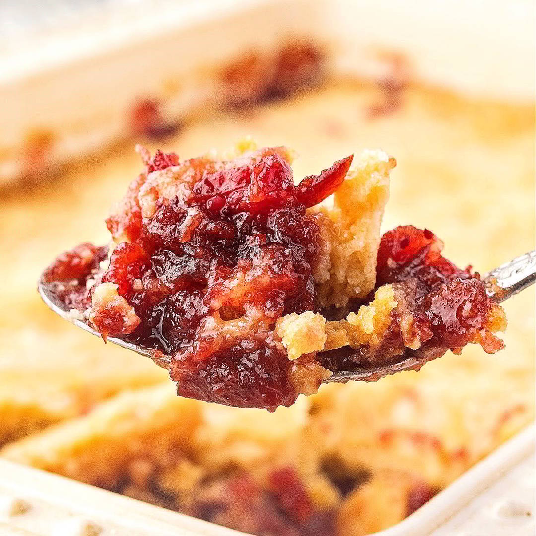 Spoon of cranberry dump cake.