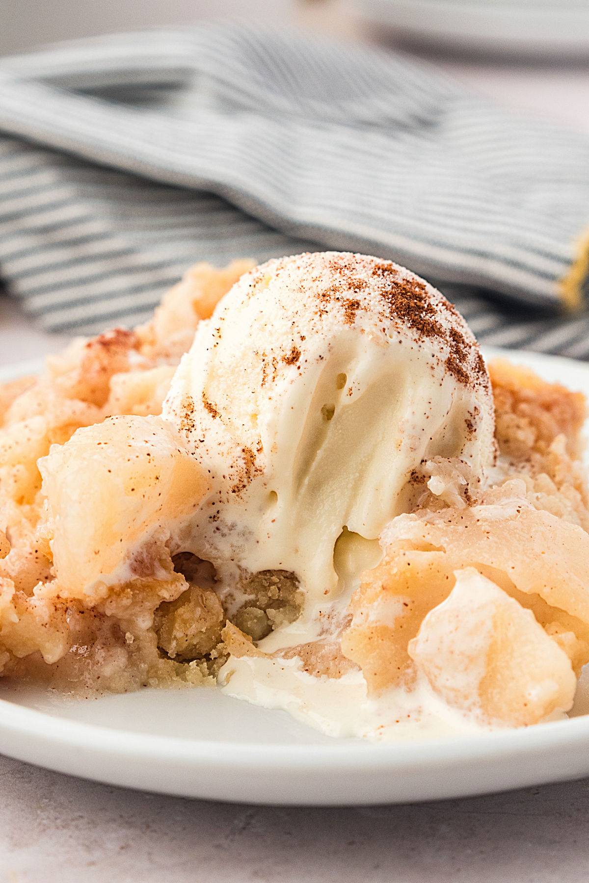 Ice cream topped pear cobbler serving.