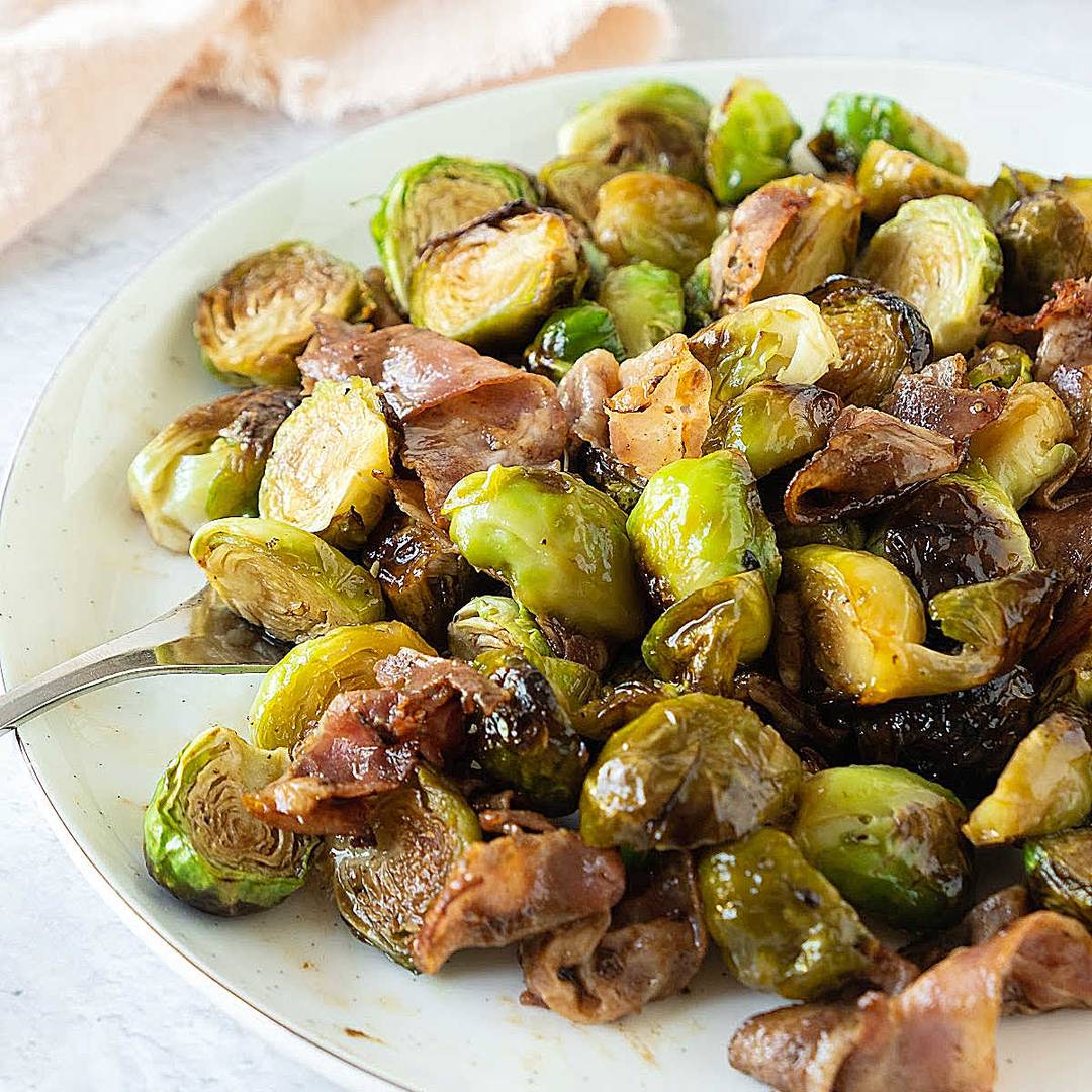White plate of bacon Brussel sprouts.