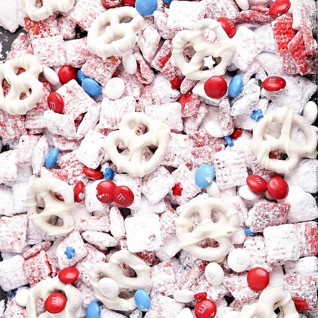White chocolate muddy buddies with red and blue candies.