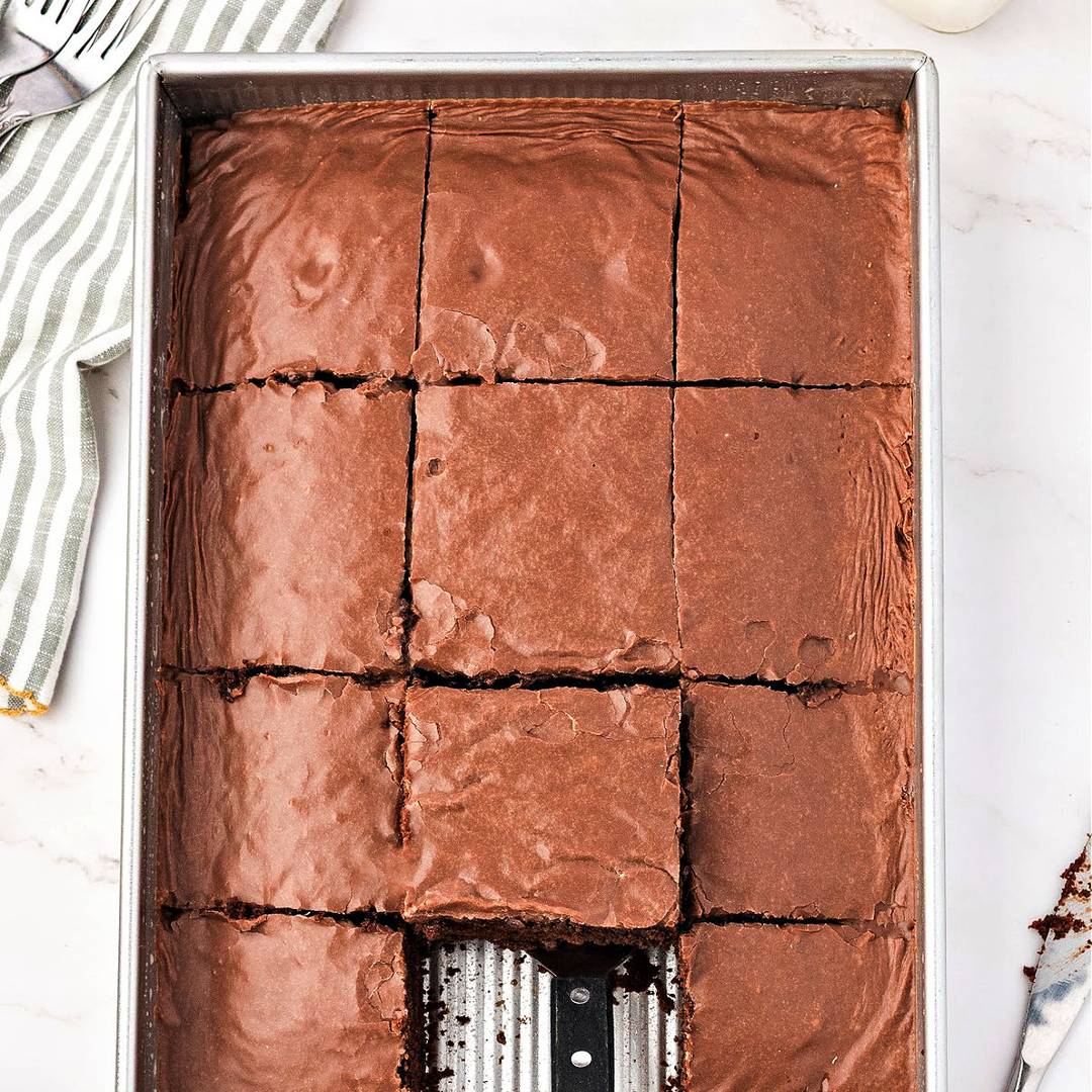 Metal pan with glazed chocolate cake.