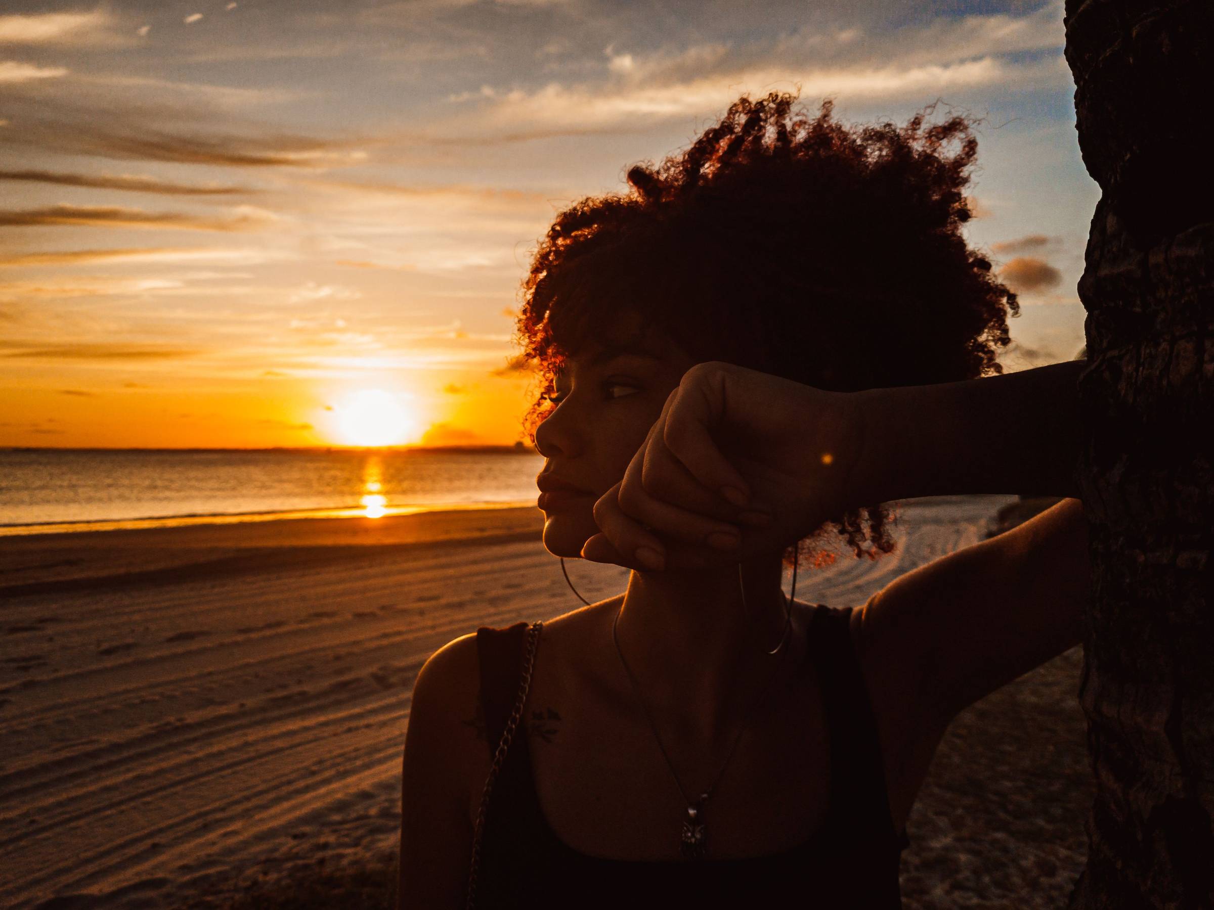 Woman in front of a sunset