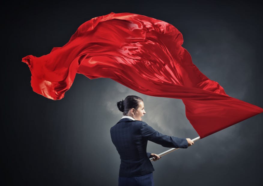 woman waving a large red flag