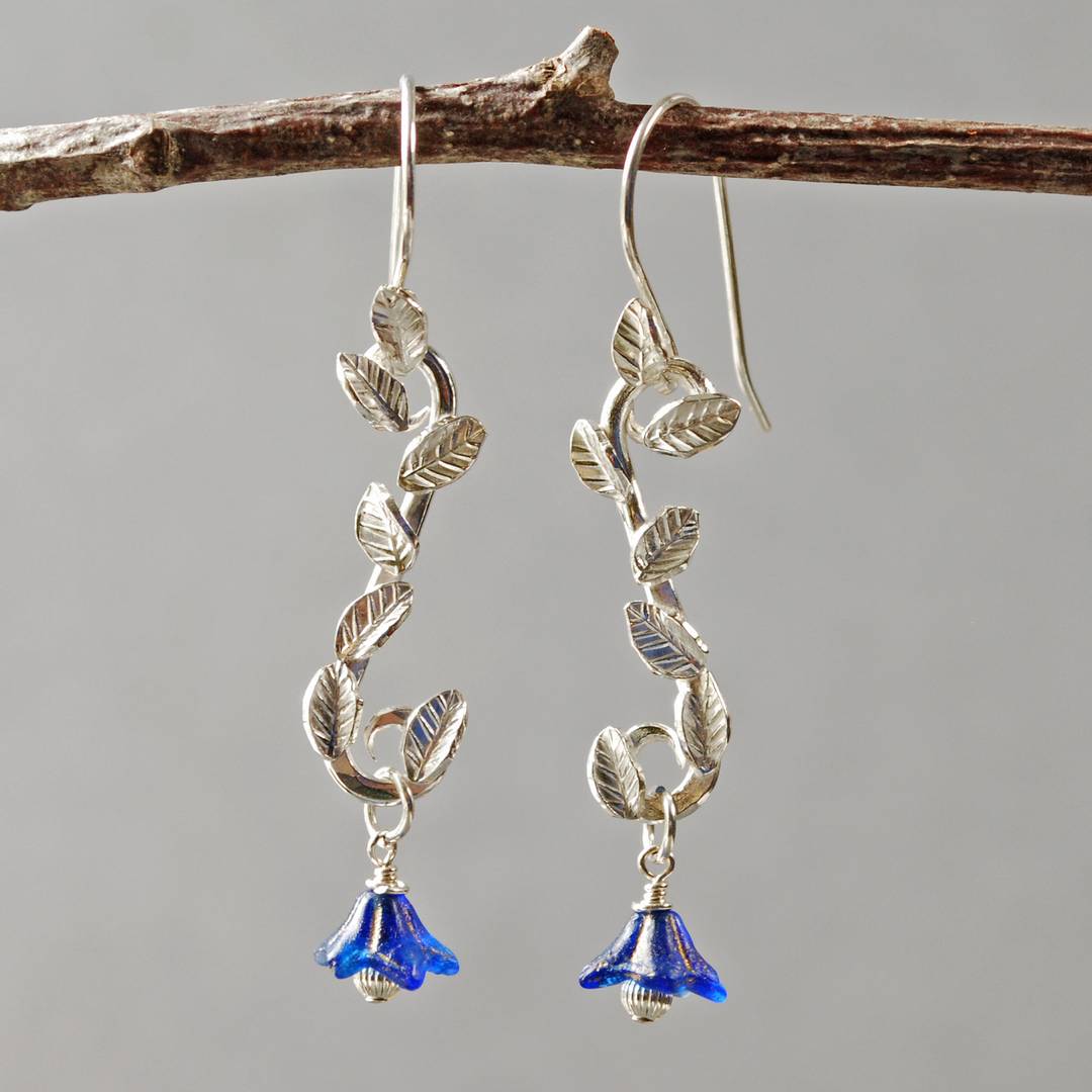 earrings with silver leaves soldered to silver branch, bell shaped blue glass flower beads at the bottom