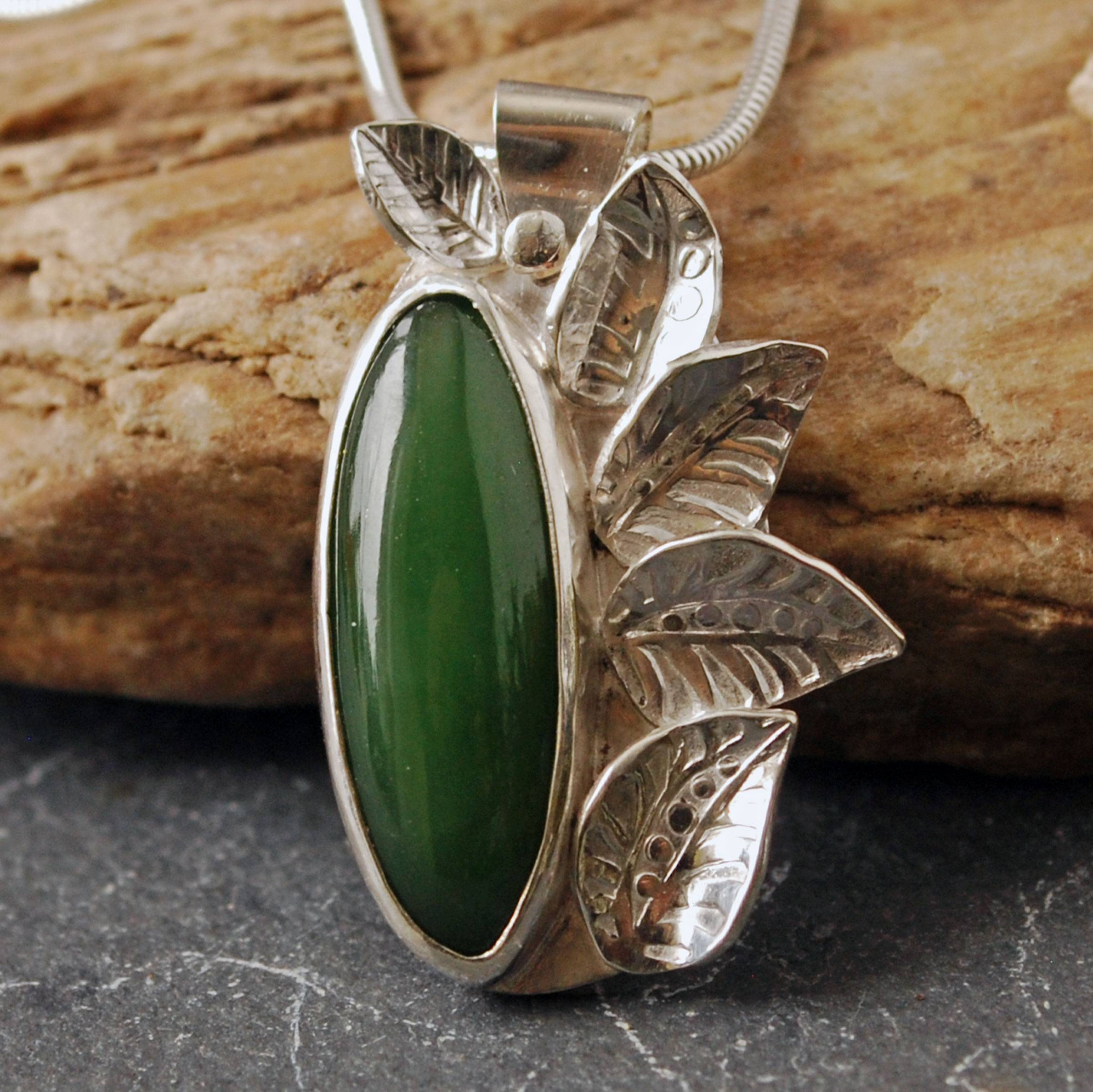 Silver pendant with jade and silver leaves