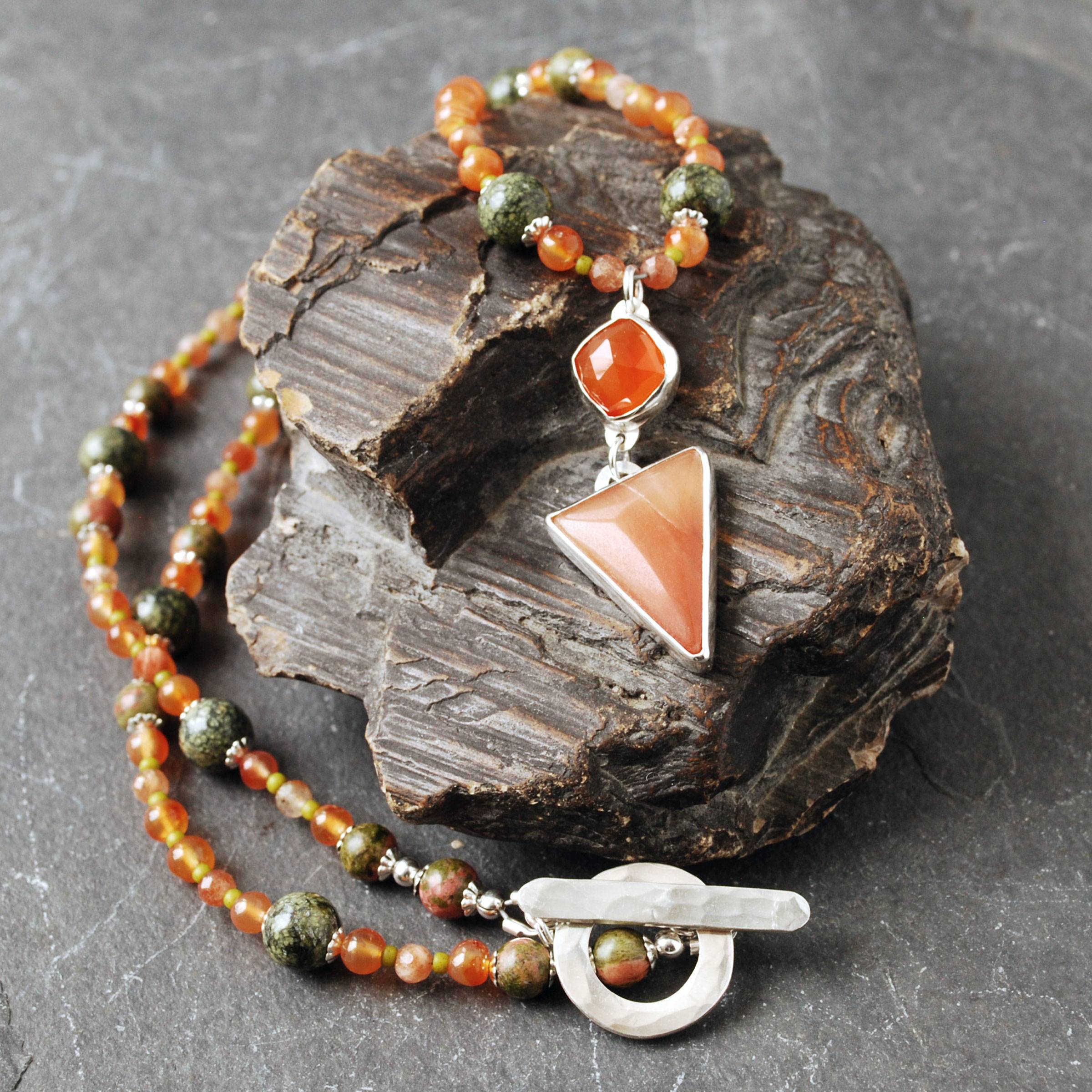 Carnelian and silver pendant on a beaded necklace