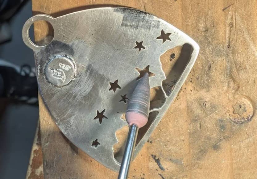 Silicon point attachment being used to polish inside of pierced designs