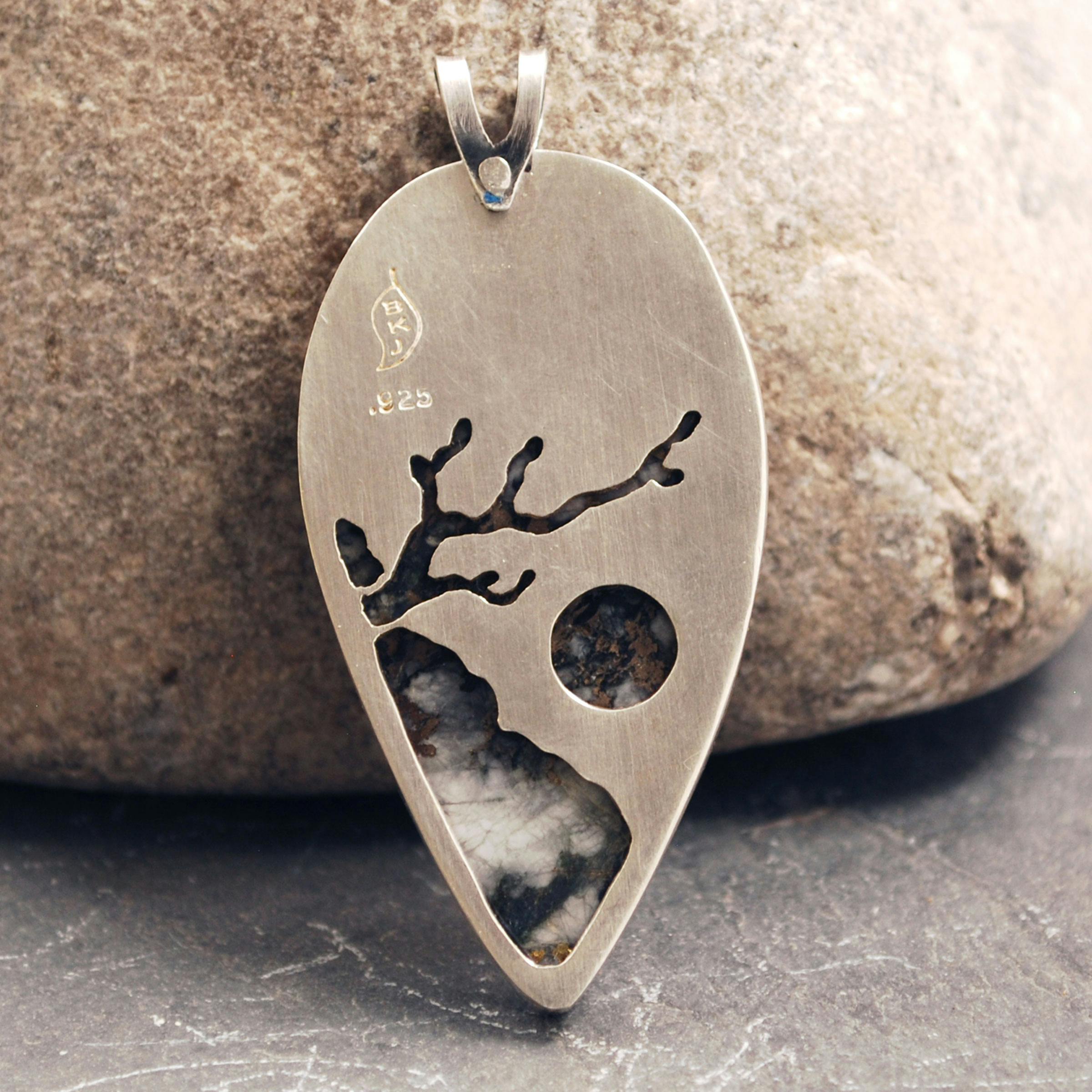 Back of pendant cut out of tree leaning from a cliff