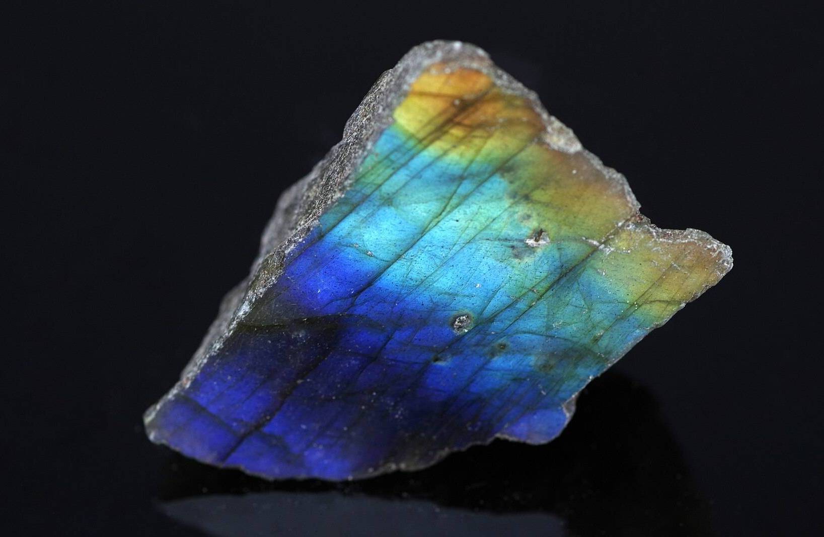 Piece of polished labradorite, showing purple, blue, light blue and gold colors.