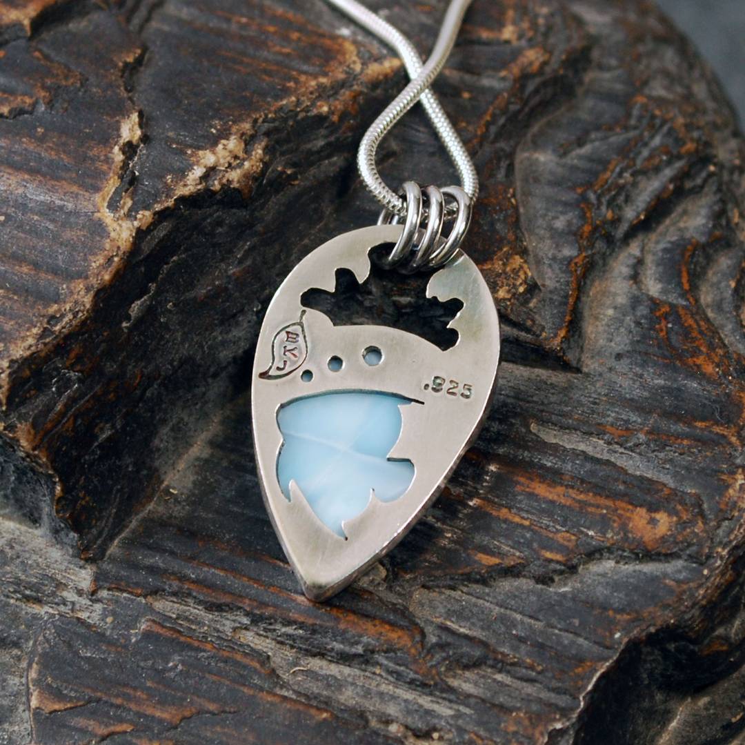 Back of larimar pendant with tropical fish cut out behind the stone