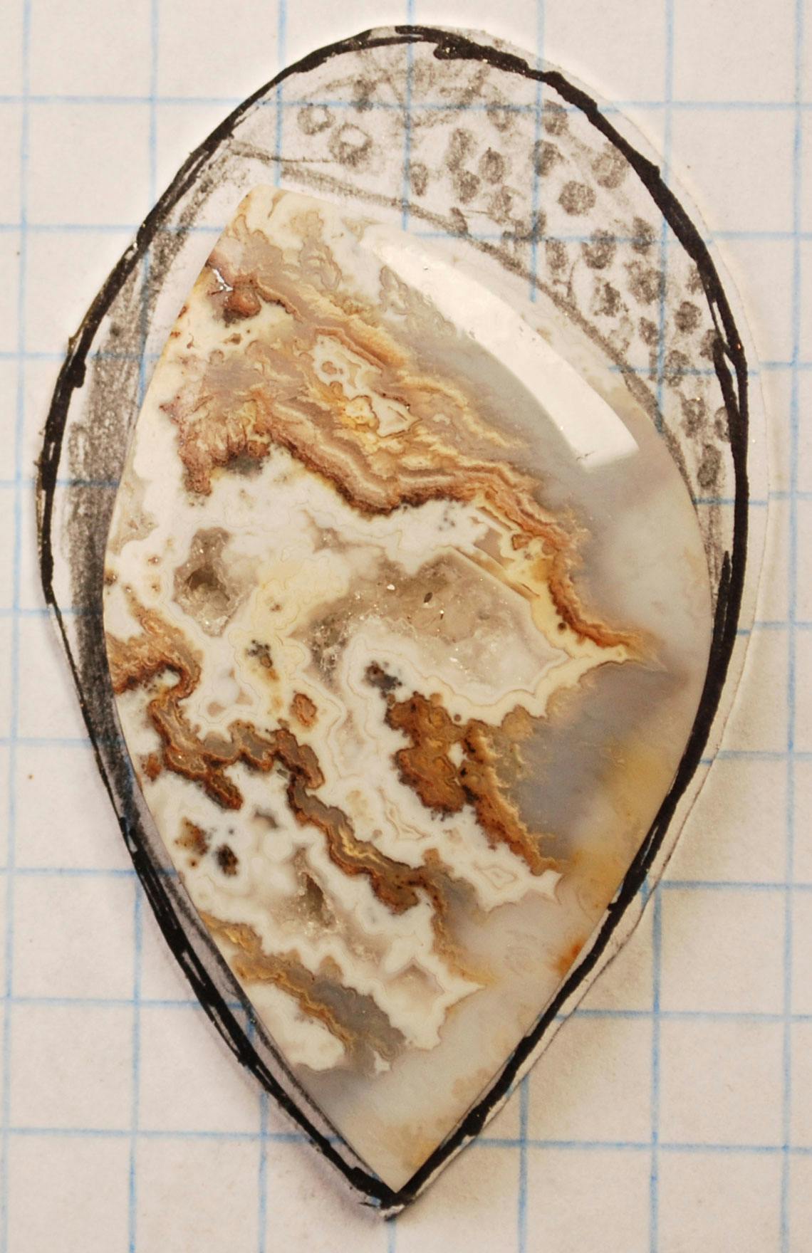 Agate cabochon with design around it, including little dots above the stonee