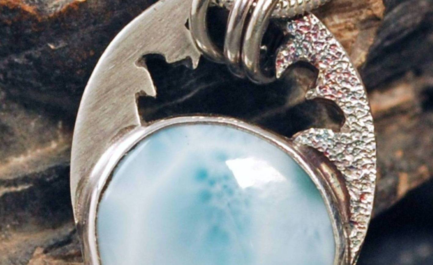 Closeup of stippled waves above the larimar pendant